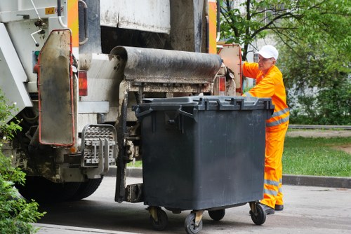 Operative reviewing safety conditions before a waste removal task